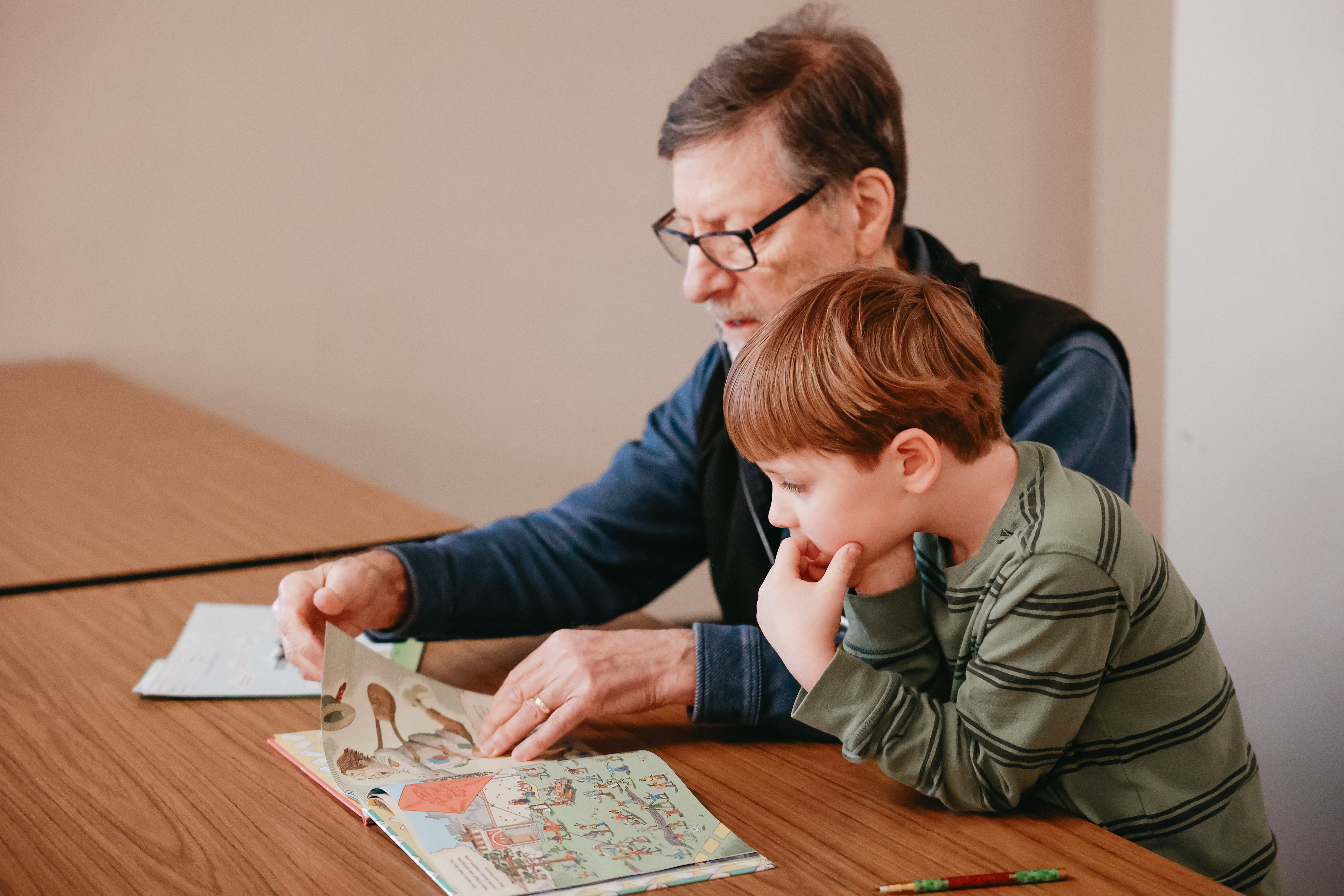 Image of man and child at SMART Reading reading together.