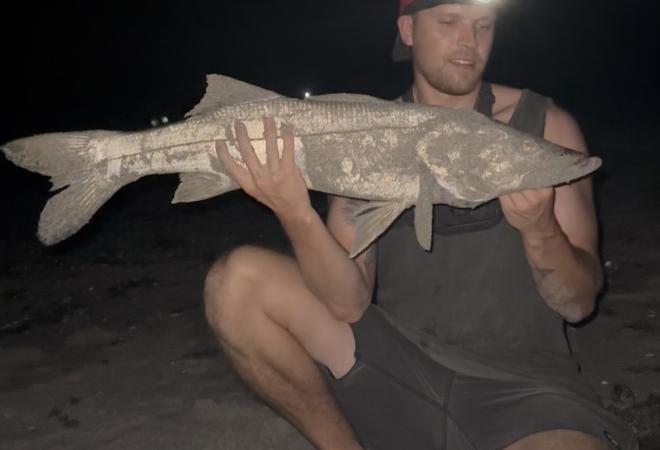Kyle Pote GIS Analyst at MFA holding a big fish 
